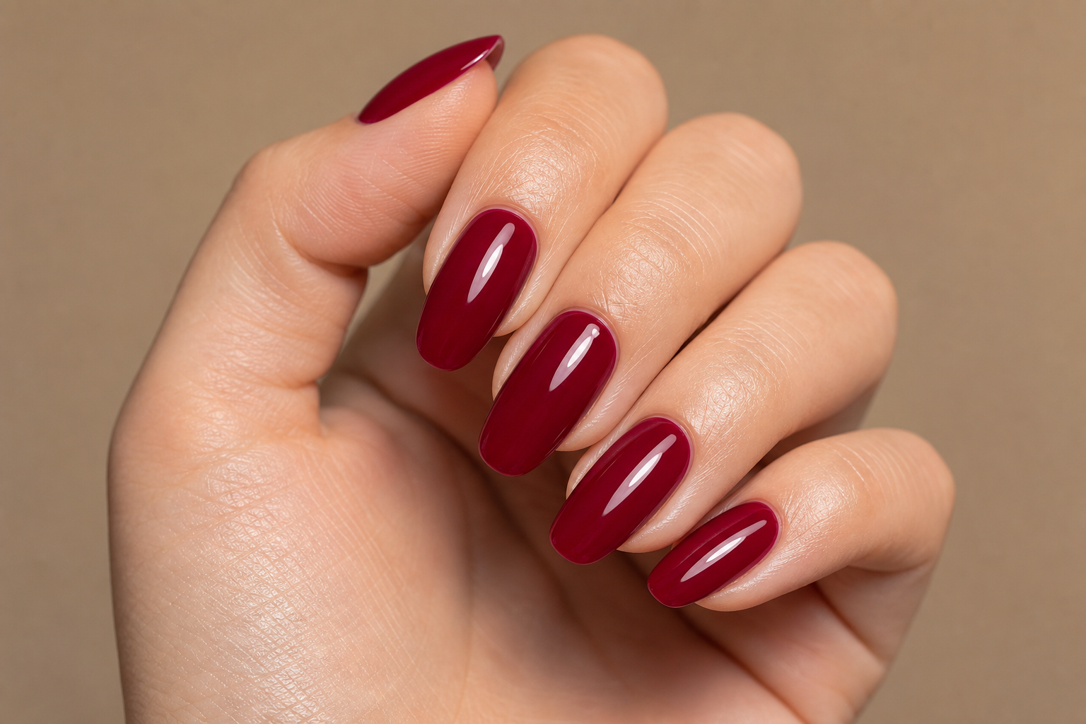 Manicura semipermanente en tono rojo vino con acabado brillante